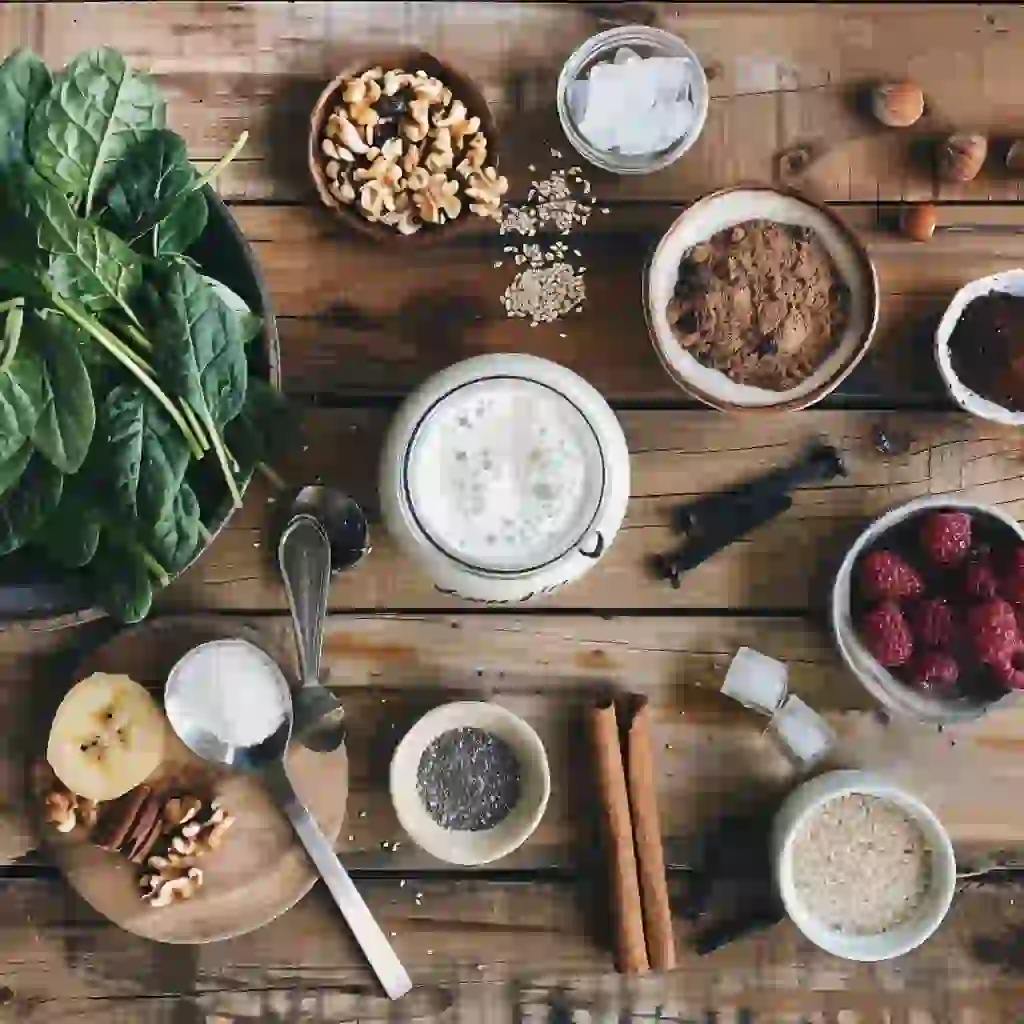 Overhead flat lay of kefir smoothie ingredients for weight loss on a wooden counter
